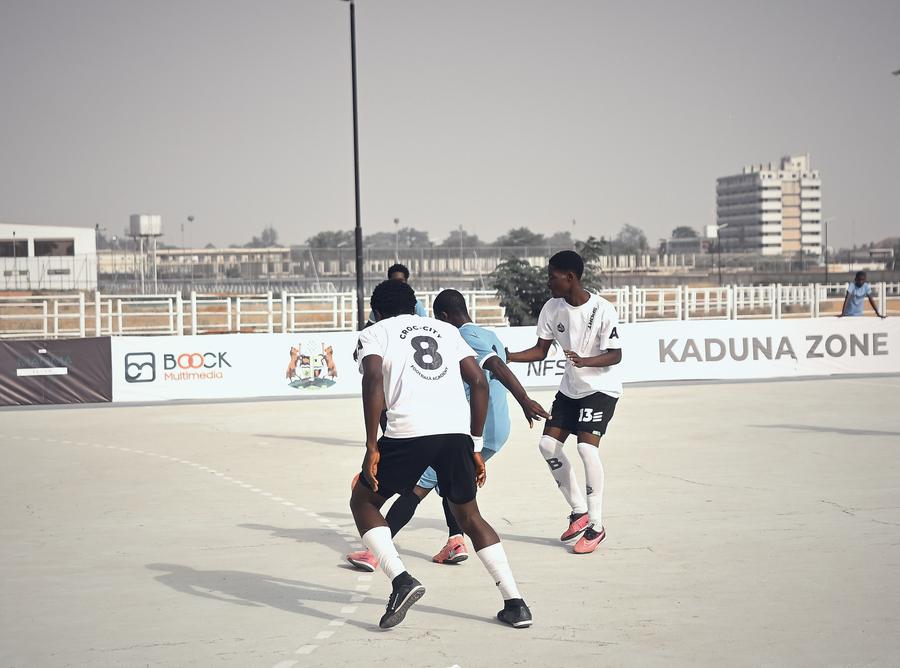 Players closing down the ball in a tight cluster