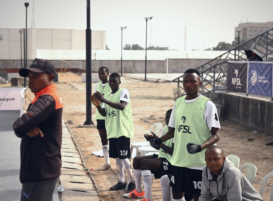 Substitutes waiting on the touchline